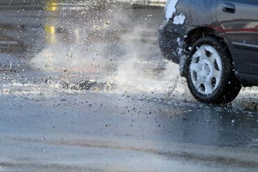 car driving through potholes with splash