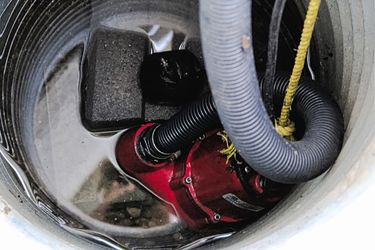 red sump pump inside home basement