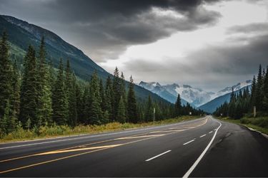 road with mountains and cloudy sky