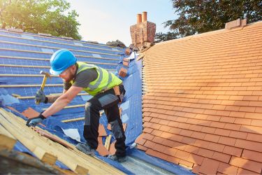 Man on roof making repairs