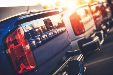 Row of parked trucks in sunset