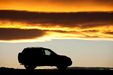 SUV driving during the sunset