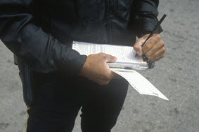 Traffic ticket being written by police officer