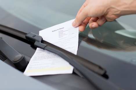 car with traffic ticket on dashboard