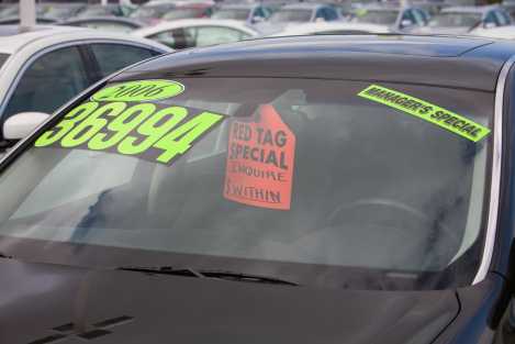 used car for sale with neon sticker sign