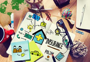 visual collage on a desk of different types of insurance