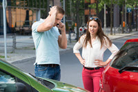 People on phone at scene of car accident