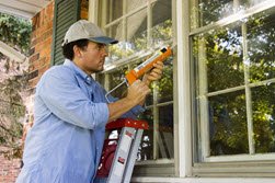 man doing exterior caulking