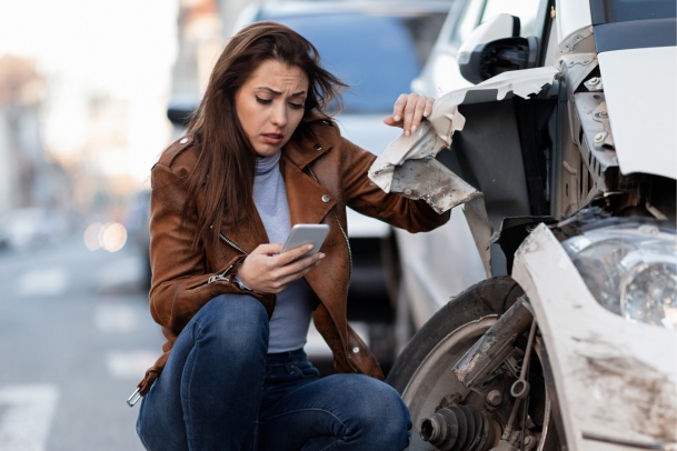 Young excited woman in a car