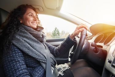 woman driving sunset in window