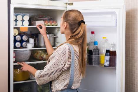woman looking inside a fridge