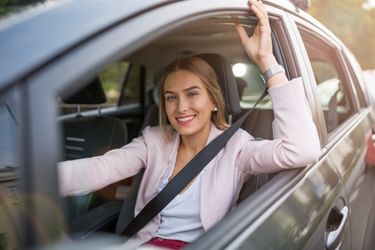 woman smiling inside car