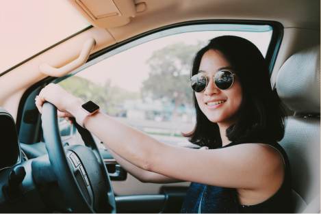 woman driving car with sun glasses