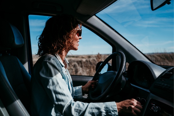 women with short hair driving a car in summer