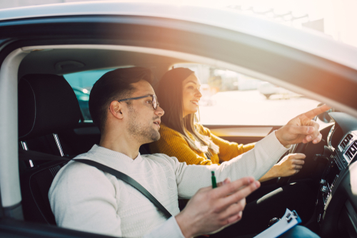 Woman driving with an instructor