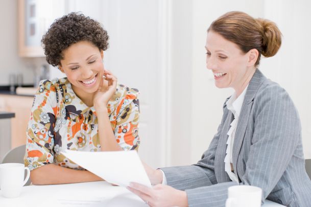 couple talking to insurance broker and reviewing insurance documents