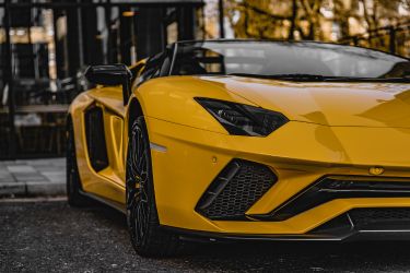 yellow sports car parked on the side of the road